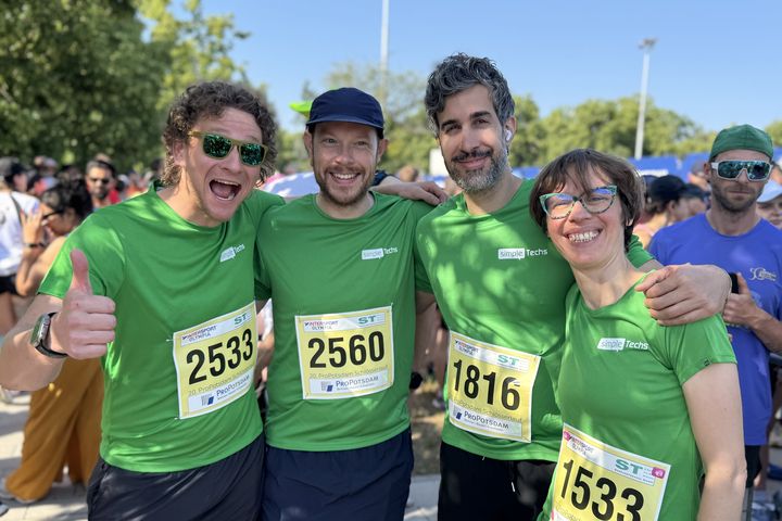 Four colleagues in simpleTechs shirts after a company run
